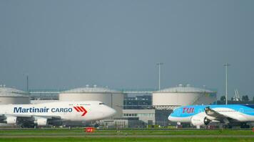 AMSTERDAM, THE NETHERLANDS JULY 26, 2017 - Martinair Cargo Boeing 747 PH MPS and TUI Fly Boeing 787 Dreamliner PH TFM before departure at runway 24 Kaagbaan. Shiphol Airport, Amsterdam, Holland video