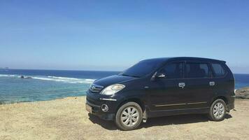 Car on the coast of the Seger Beach, Lombok, Indonesia photo