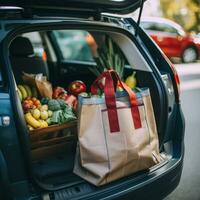 Shopping bag with groceries and car parking in the back photo