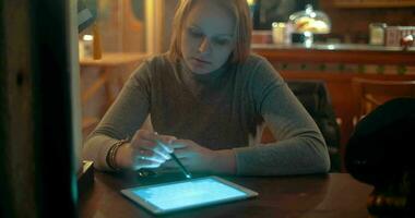 Woman Using Tablet PC with Stylus in Cafe video