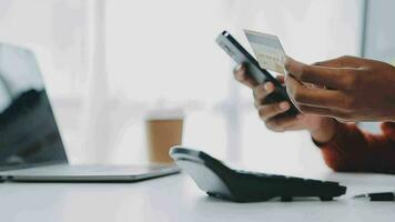 Making Financial Transaction. Closeup of black girl showing credit card and using cell phone with empty screen, mock up video