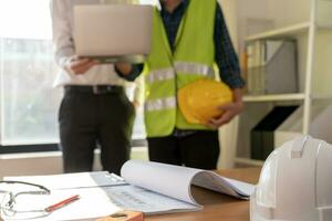 Engineers team and owner discuss check and review the laptop of construction. Contractor inspection drawing before start project civil. project planning, consulting, architecture. photo