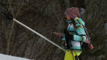 Female skier on a drag lift make selfie, Belokurikha resort video