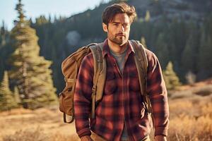 Handsome bearded man with backpack in the autumn forest. Travel and adventure concept. photo