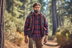 Handsome bearded man with backpack in the autumn forest. Travel and adventure concept. photo