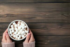 Female hands holding a cup of hot cocoa with marshmallows on wooden background. Top view with copy space. Generative AI photo