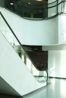 shadow and light reflection inside the building view and moving escalator near glass mirror window photo