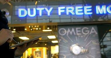 Woman with pad on escalator in Duty Free Moscow video