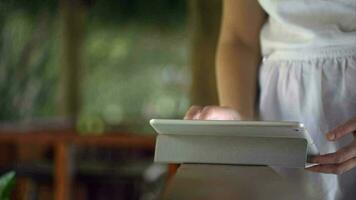 Woman using tablet computer on handrail video