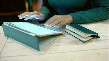 Woman working with pad and taking notes in notebook video