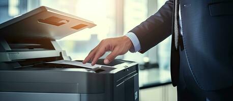 Office workers utilize a panel to operate a printer or photocopier for scanning and printing documents photo
