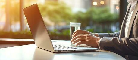 Business professionals working on a laptop and other devices with a blurred home background photo