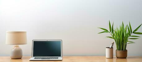 Modern room with desk holding laptop vase of bamboo photo