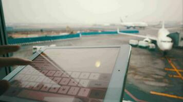 Using touch pad by the window at airport video