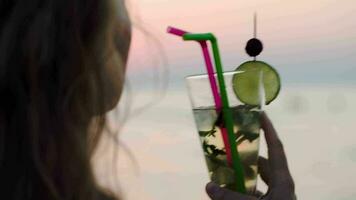 Woman drinking mojito with a straw video