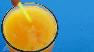 Stirring up ice in fruit juice video