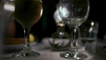 Pouring wine into empty glass in restaurant video