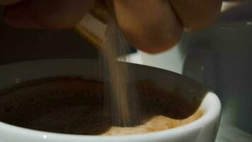 Putting sugar into cup with coffee video