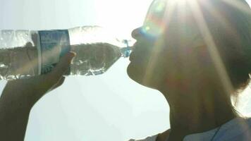 Woman drinking water in sunlight video
