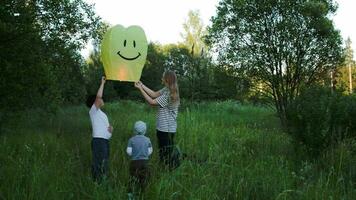 Mother with two sons flying smiling fire lantern video