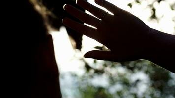 Woman playing with evening sun outdoor video