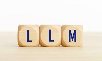 LLM or Large Language Model text on wooden blocks. Copy space photo