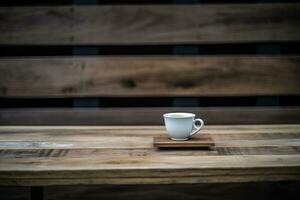 hot cup of coffee resting on a rustic wooden table photo