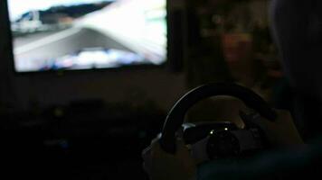 Playing racing game with steering wheel simulator video