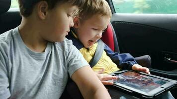 Boys with tablet computer during traveling by car video