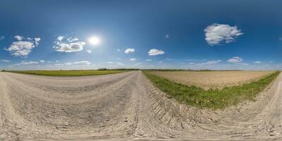 360 hdri panorama on gravel road with clouds and sun on blue sky in equirectangular spherical  seamless projection, use as sky replacement in drone panoramas, game development sky dome or VR content photo