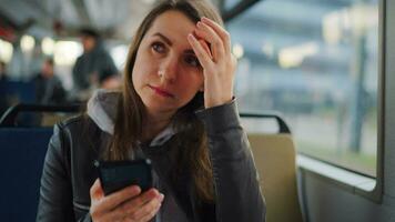 Public transport. Woman in tram using smartphone video