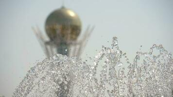 Baiterek Tower the symbol of Nur Sultan, capital of Kazakhstan with fountain foreground, slow motion video