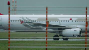 DUSSELDORF, GERMANY JULY 24, 2017 - Turkish Airlines Airbus A321 TC JRI taxiing after landing, rainy weather. Dusseldorf airport video