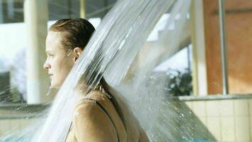 Frau genießen stark Wasser Dusche im das Schwimmbad video