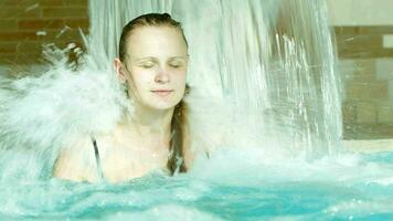 Woman under water shower in the swimming pool video