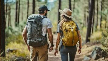 Cheerful couple of hikers in casual clothes with backpacks walking on path in forest and smiling during hiking trip. Generative AI photo