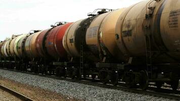 Freight train with tank cars passing by video