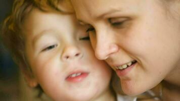 Loving family of son and mother kissing each other video