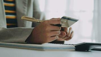 Close up woman hand using credit card and smartphone laptop for buying online shopping video