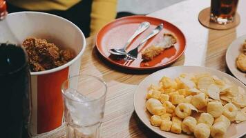 people are eating food, fried chicken together. video