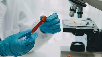 hand of scientist with test tube and flask in medical chemistry lab blue banner background video