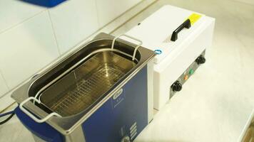 Beautician putting reusable instrument into sterilizer video