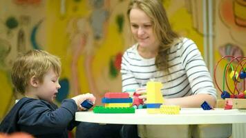 Mother and son playing together with toys video