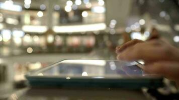 Woman using tab on handrails in shopping center video