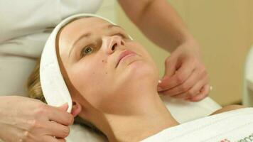 Woman being prepared for facial spa procedures video