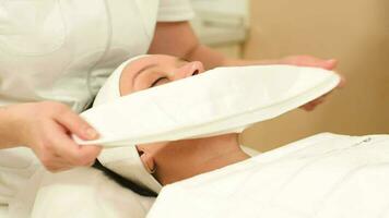 Woman getting face therapy at beauty salon video