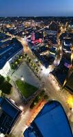Aerial Vertical Panoramic View of Illuminated Downtown Buildings, Roads and Central Luton City of England UK at Beginning of Clear Weather's Night of September 5th, 2023 photo