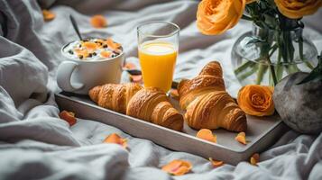 Breakfast in bed concept. White tray with glass half full of fresh orange juice and french croissant bagel, blankets, colorful wildflowers. Close up, Generative AI photo