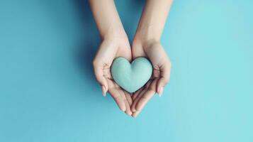 Concept Happy Mother's Day or International Day of Families. Happy women's day. Heart in the hands of daughter and mother on a blue background. I love you. Greeting card. Top view. Generative ai photo