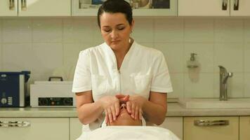Massage therapist making facial massage at beauty spa video